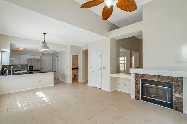 5014 Sterling Manor Dr, Tampa, FL 33647 - unfurnished living room with light tile patterned floors, a ceiling fan, a sink, and baseboards