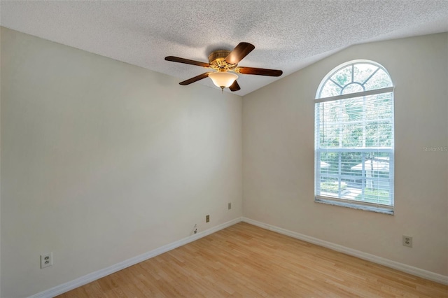 5014 Sterling Manor Dr, Tampa, FL 33647 - spare room with light wood-style flooring, a textured ceiling, ceiling fan, lofted ceiling, and baseboards
