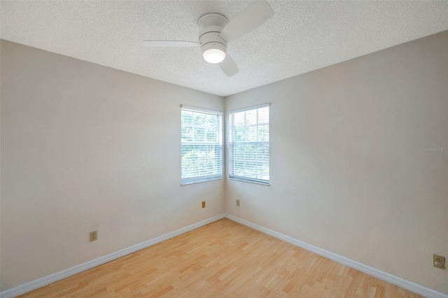 5014 Sterling Manor Dr, Tampa, FL 33647 - spare room featuring light wood-type flooring, a textured ceiling, ceiling fan, and baseboards