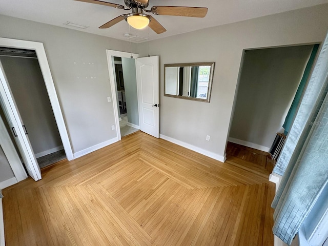 unfurnished bedroom with a ceiling fan, visible vents, and baseboards