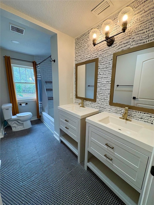 full bathroom with a sink, visible vents, and toilet