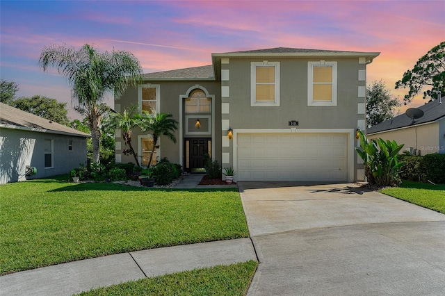 view of front of property with a shingled roof, concrete driveway, stucco siding, a lawn, and an attached garage