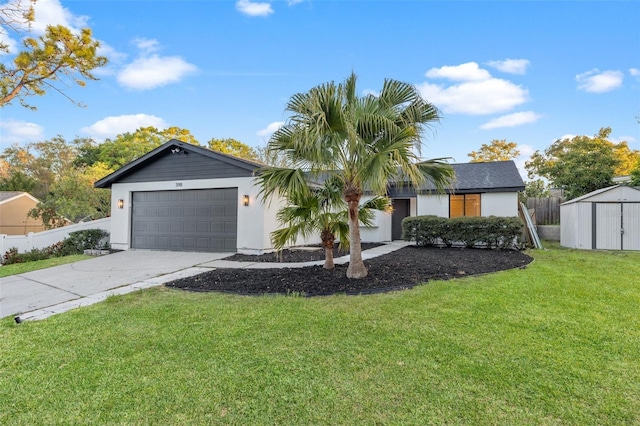 single story home with a front lawn, a shed, fence, concrete driveway, and an attached garage