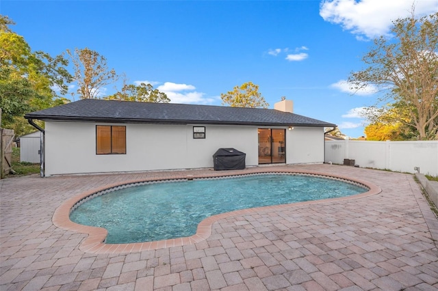 view of pool with a patio, a fenced in pool, fence, and grilling area