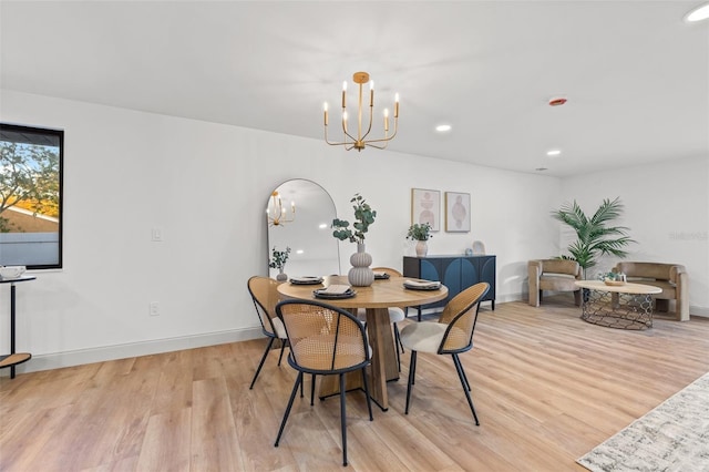 dining room with a chandelier, recessed lighting, baseboards, and light wood-style floors