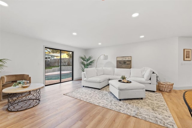 living area with recessed lighting, baseboards, and wood finished floors