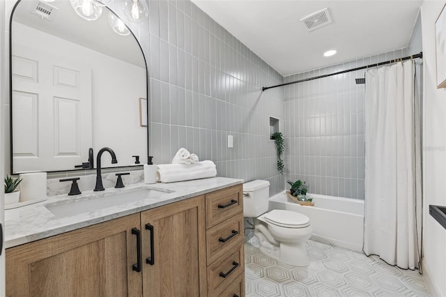 bathroom featuring visible vents, shower / bath combo with shower curtain, toilet, and vanity