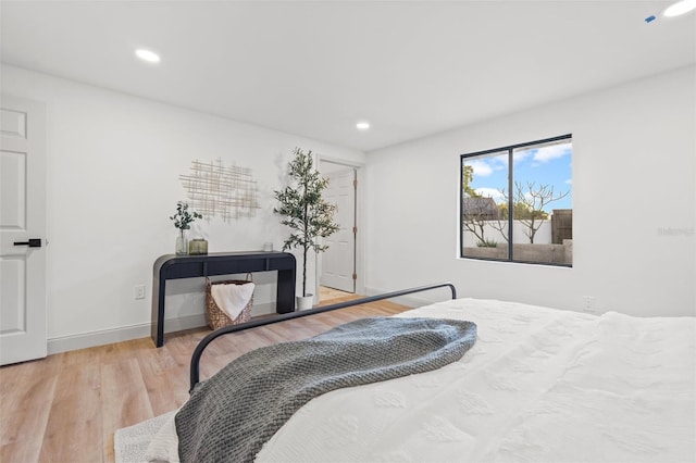 bedroom with recessed lighting, baseboards, and wood finished floors