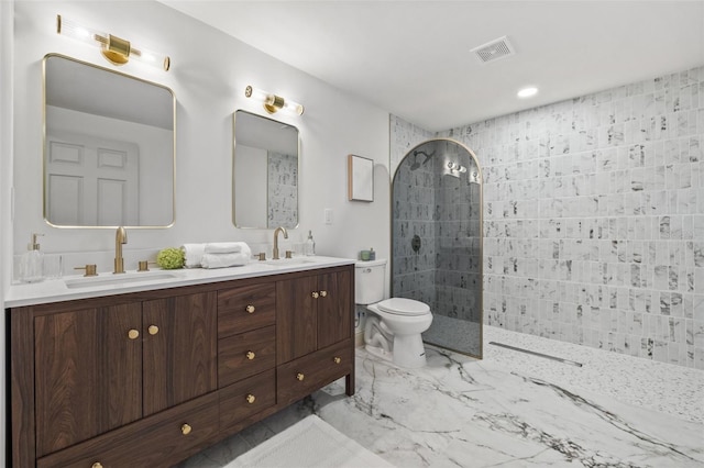 bathroom featuring visible vents, marble finish floor, walk in shower, and a sink