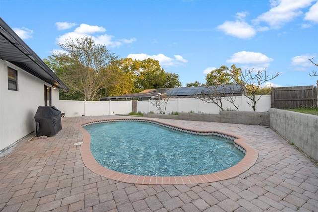 view of pool featuring a patio, a fenced backyard, a fenced in pool, and a grill