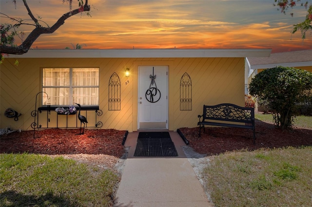view of exterior entry at dusk