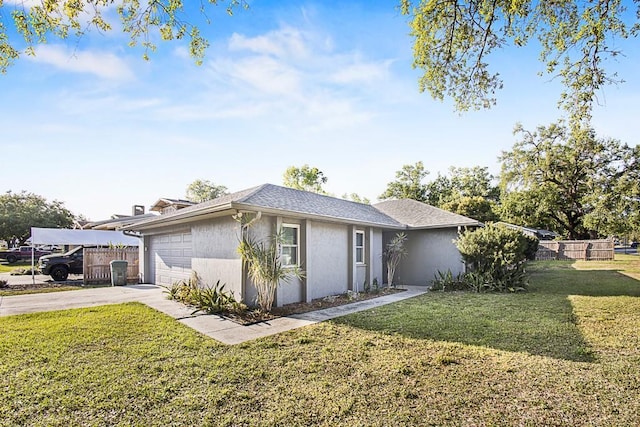 view of front of property with stucco siding, driveway, fence, a front yard, and a garage