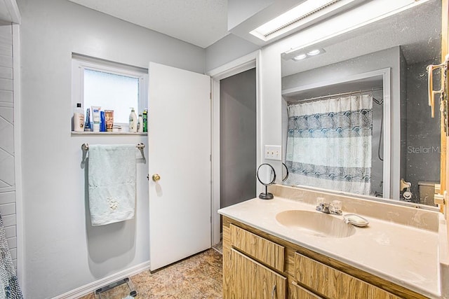 bathroom with a textured ceiling, vanity, and a shower with shower curtain