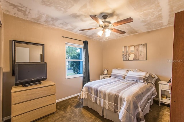 bedroom featuring ceiling fan, baseboards, and dark colored carpet