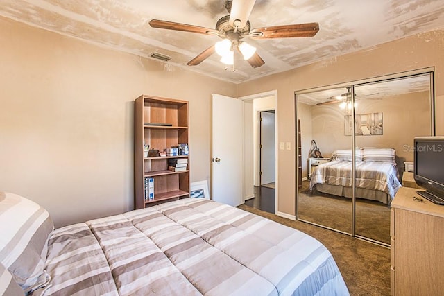 carpeted bedroom with a closet, visible vents, and a ceiling fan