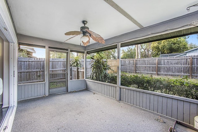 unfurnished sunroom with a healthy amount of sunlight and ceiling fan