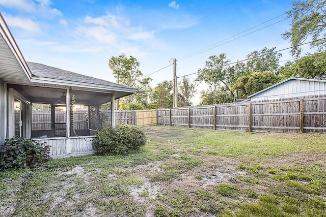 view of yard with a fenced backyard and a sunroom