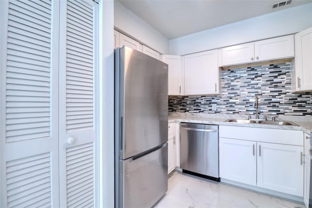 kitchen featuring visible vents, stainless steel appliances, marble finish floor, white cabinetry, and a sink