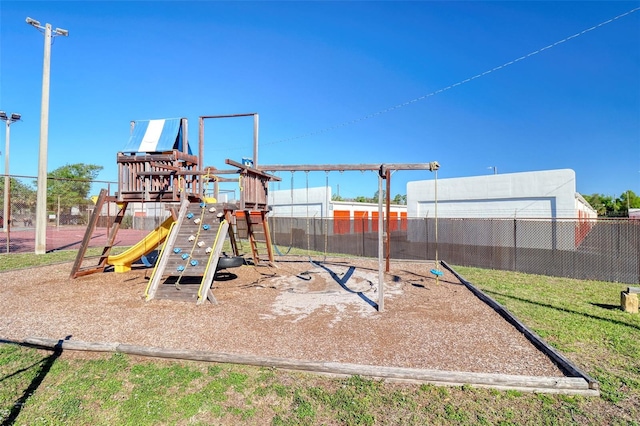 communal playground with a lawn and fence