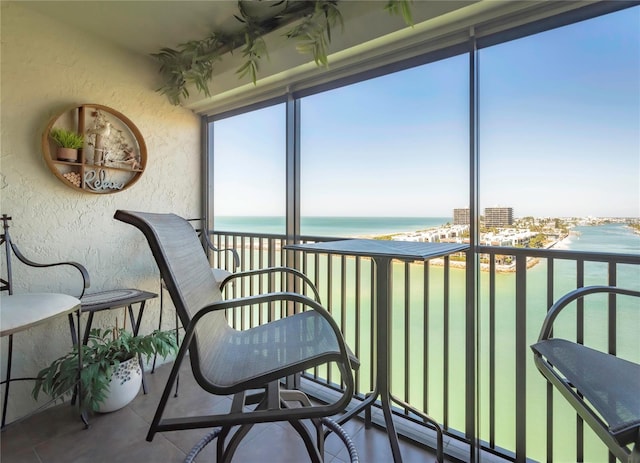 sunroom / solarium featuring a water view