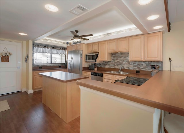 kitchen featuring visible vents, dark wood-type flooring, appliances with stainless steel finishes, and light brown cabinets