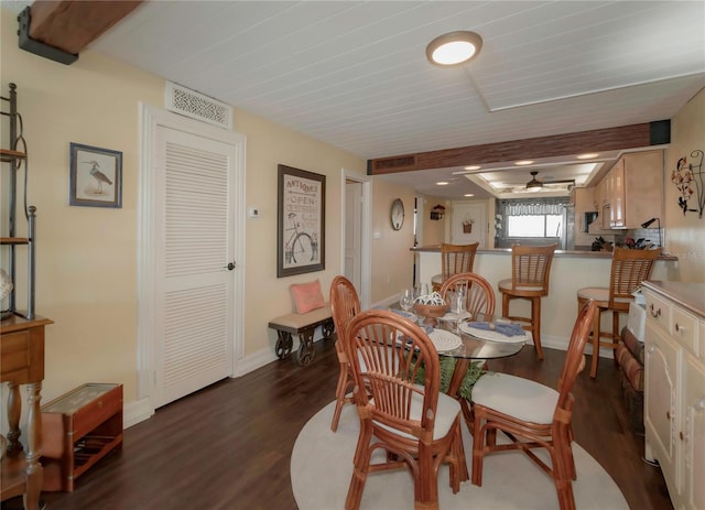 dining area with a ceiling fan, dark wood-style floors, visible vents, and baseboards