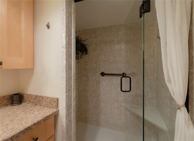 bathroom with a stall shower and vanity