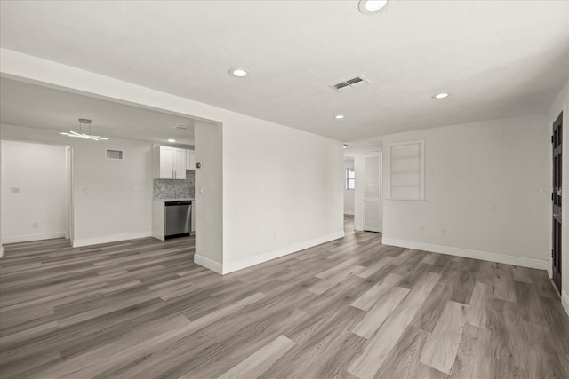 unfurnished living room with recessed lighting, visible vents, baseboards, and light wood-style floors