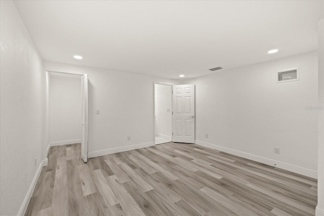 spare room featuring recessed lighting, visible vents, baseboards, and light wood-style floors