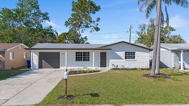 ranch-style home featuring a garage, stone siding, concrete driveway, and a front lawn