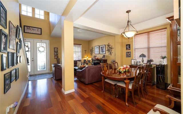 dining room featuring dark wood finished floors and baseboards