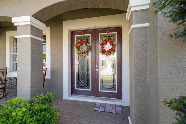 entrance to property with stucco siding