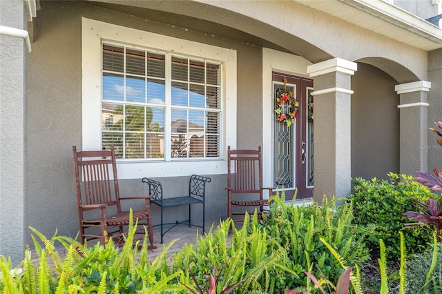 entrance to property featuring stucco siding