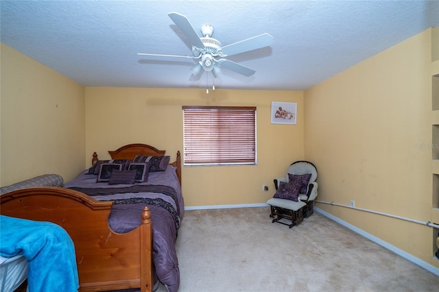 carpeted bedroom featuring ceiling fan, baseboards, and a textured ceiling