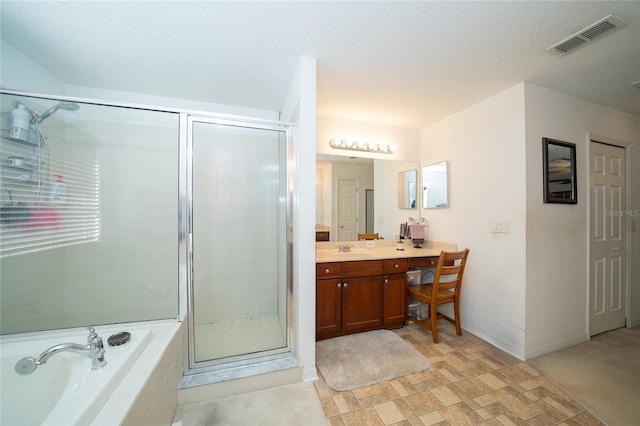 bathroom with visible vents, a shower stall, baseboards, a garden tub, and vanity