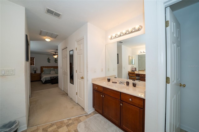 ensuite bathroom featuring visible vents, a ceiling fan, connected bathroom, and vanity