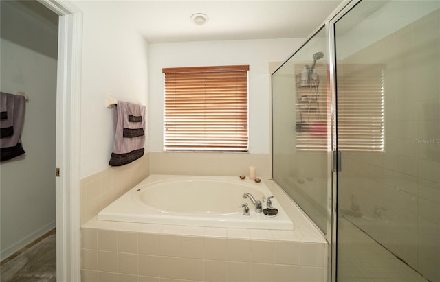 full bathroom featuring a garden tub and a shower stall