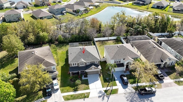 drone / aerial view featuring a residential view and a water view