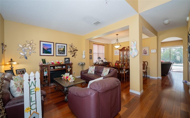 7653 Stoney Hill Dr, Wesley Chapel, FL 33545 - living area with arched walkways, visible vents, baseboards, and wood finished floors
