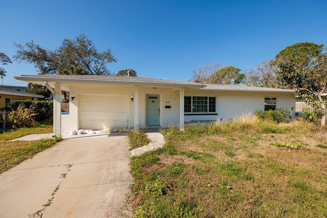 ranch-style home featuring concrete driveway and a garage