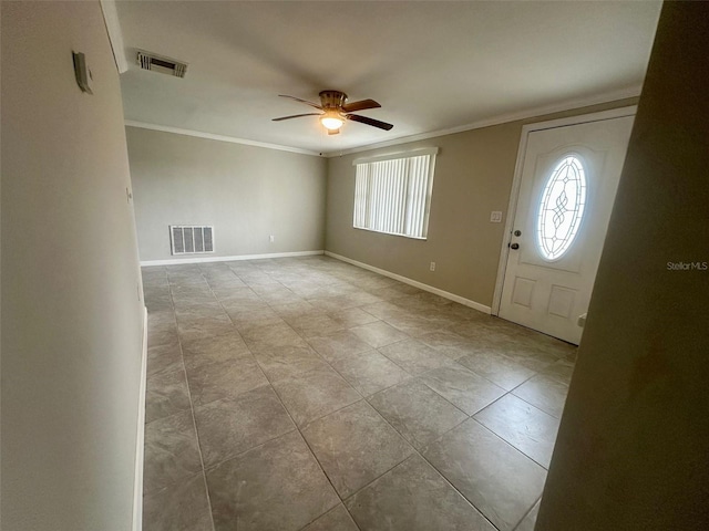 foyer entrance with visible vents, plenty of natural light, ornamental molding, and a ceiling fan