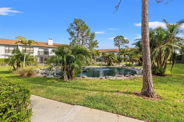 1986 Pelican Landing Blvd Unit 1514, Clearwater, FL 33762 - surrounding community with a yard and a water view