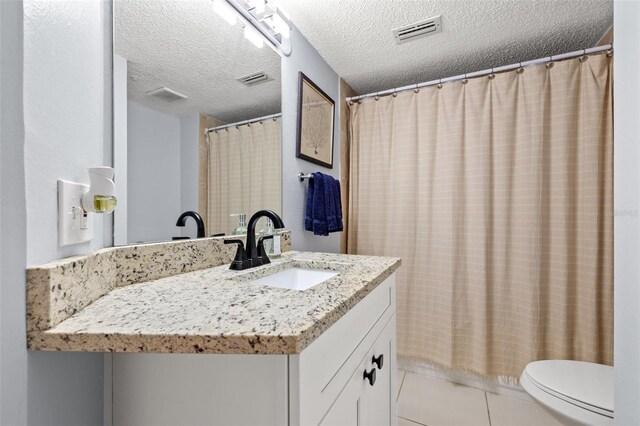 1986 Pelican Landing Blvd Unit 1514, Clearwater, FL 33762 - bathroom featuring tile patterned floors, visible vents, toilet, a textured ceiling, and vanity