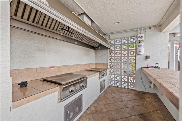 1986 Pelican Landing Blvd Unit 1514, Clearwater, FL 33762 - view of patio / terrace with a grill and exterior kitchen