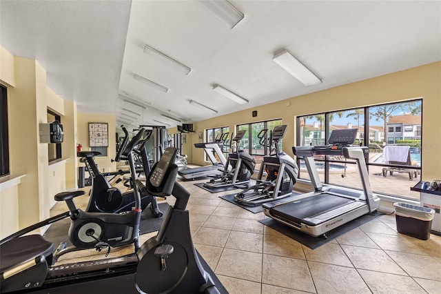 1986 Pelican Landing Blvd Unit 1514, Clearwater, FL 33762 - exercise room featuring light tile patterned floors and vaulted ceiling