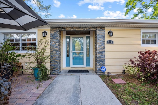 entrance to property with stone siding