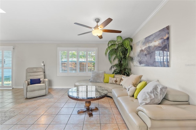 tiled living area featuring a healthy amount of sunlight, baseboards, crown molding, and a ceiling fan