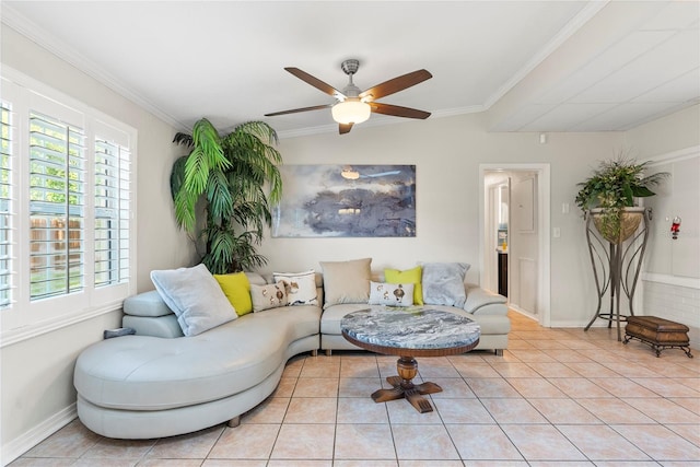 living area featuring crown molding, light tile patterned floors, baseboards, and ceiling fan