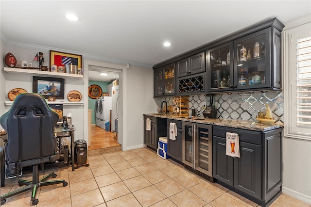 bar with crown molding, beverage cooler, indoor wet bar, decorative backsplash, and light tile patterned flooring