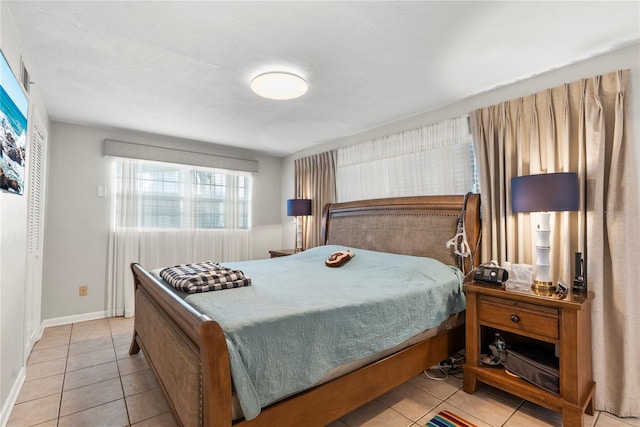 tiled bedroom featuring baseboards